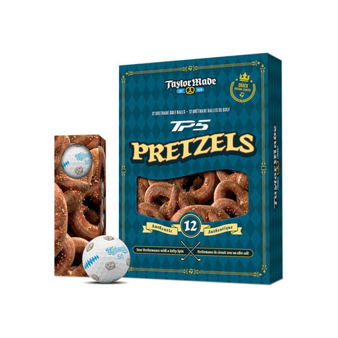 TaylorMade TP5 Pretzels-emballagekasse i mørk blågrøn med gulddetaljer, vist sammen med et mindre billede af kassen set fra siden og to hvide Golfbolde med produktlogoet trykt på en ensfarvet hvid baggrund.
